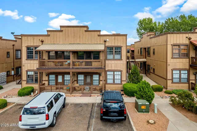 a view of a house with a backyard and a tree