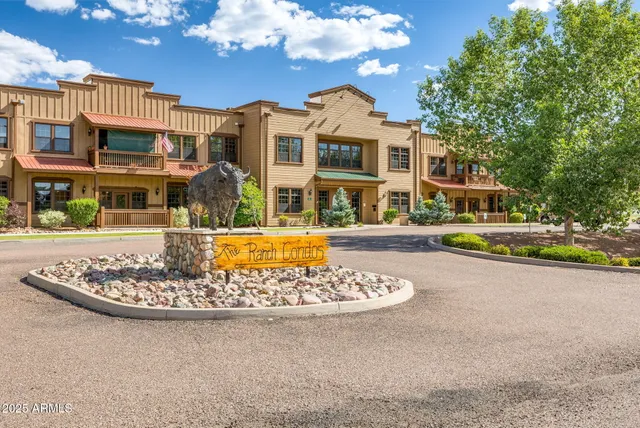 a living room with furniture a fireplace and a chandelier