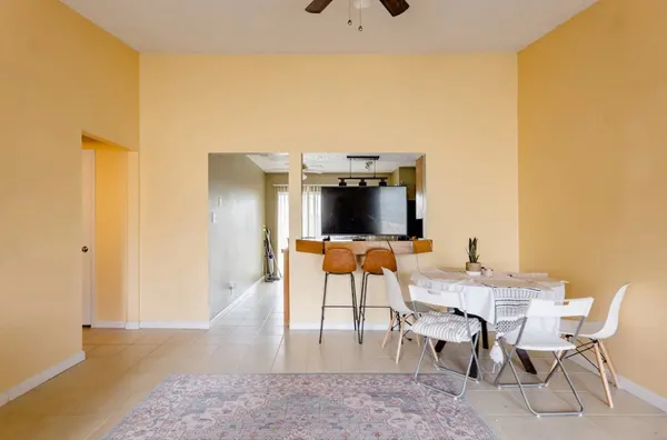a dining room with furniture and a flat screen tv