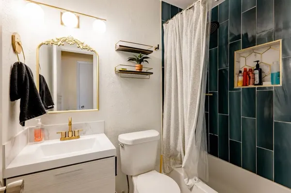 a bathroom with a toilet sink and mirror