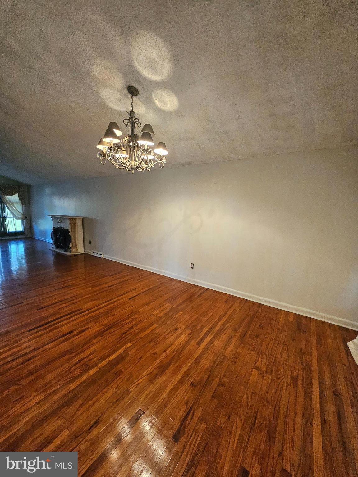 148 Church Road Elkins Park, PA 19027 - Photo 11 of 33 a view of a room with wooden floor and a ceiling fan