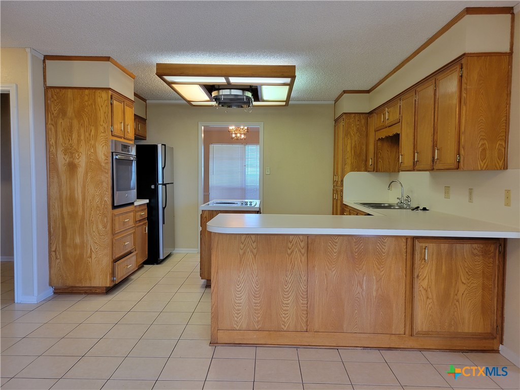 1511 Wild Ridge Drive Harker Heights, TX 76548 - Photo 11 of 29 a kitchen with stainless steel appliances granite countertop a refrigerator and a sink
