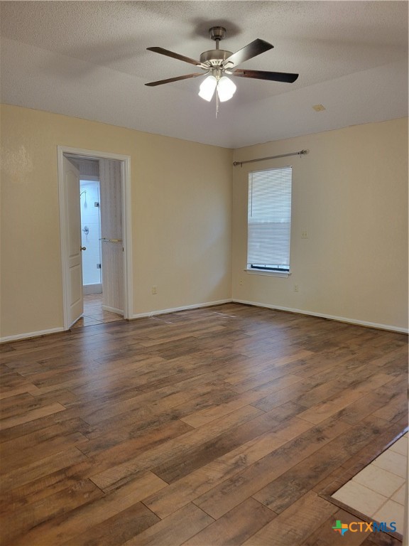 1511 Wild Ridge Drive Harker Heights, TX 76548 - Photo 17 of 29 an empty room with wooden floor chandelier fan and windows