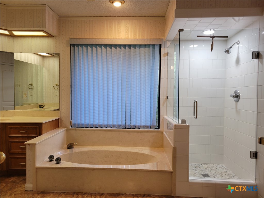 1511 Wild Ridge Drive Harker Heights, TX 76548 - Photo 19 of 29 a bathroom with a tub a shower and a sink