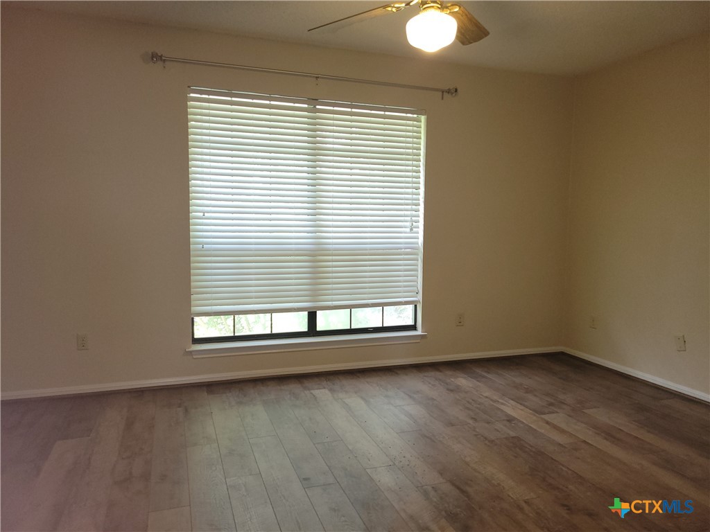 1511 Wild Ridge Drive Harker Heights, TX 76548 - Photo 27 of 29 an empty room with wooden floor and windows