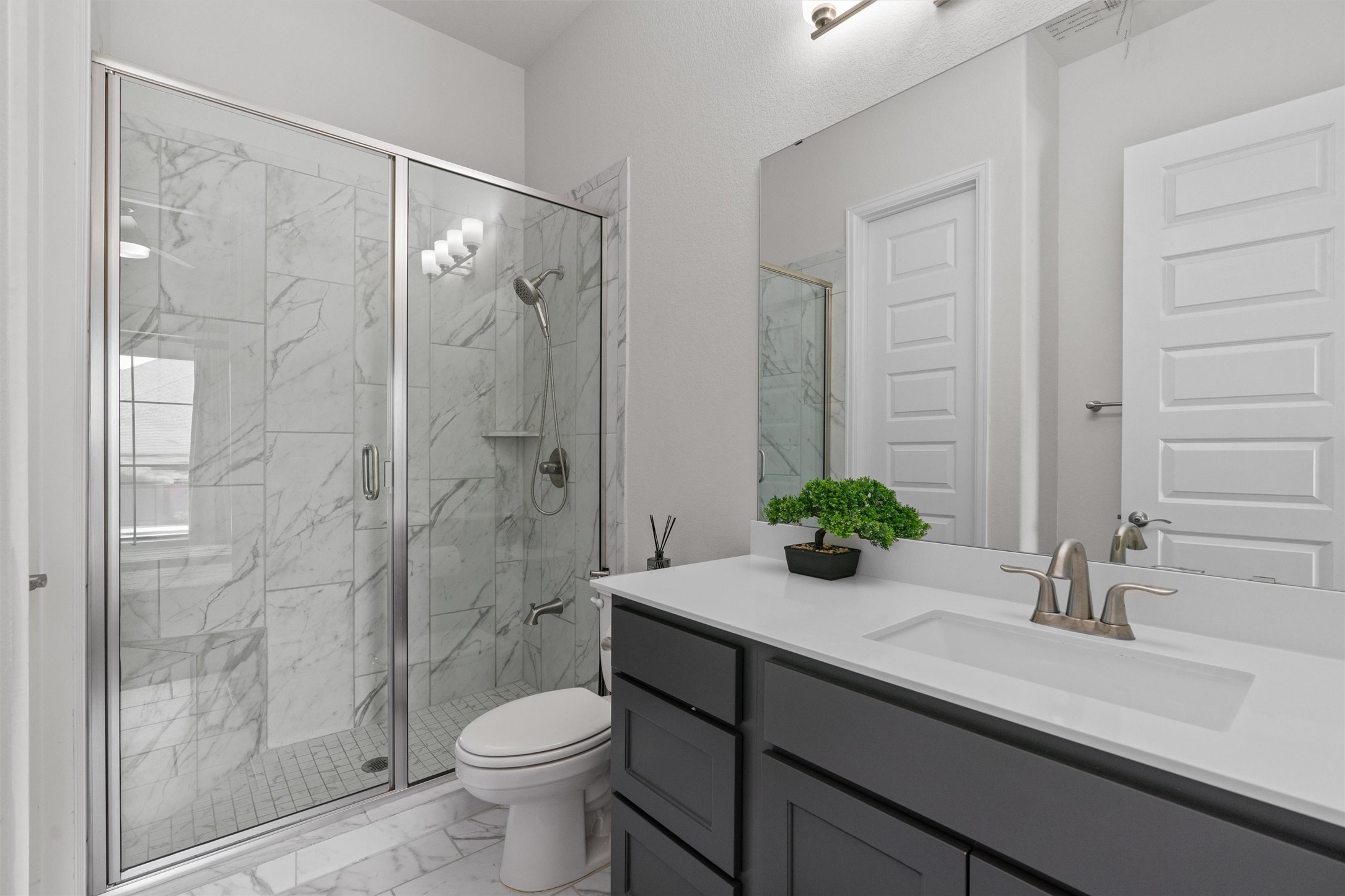 101 Pienza Drive Georgetown, TX 78628 - Photo 32 of 40 a bathroom with a sink a toilet and shower