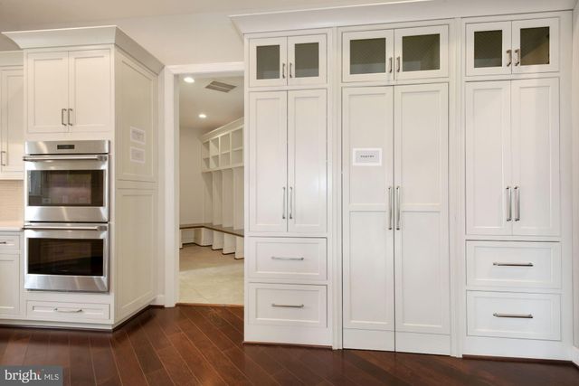 a view of an entryway with wooden floor and staircase