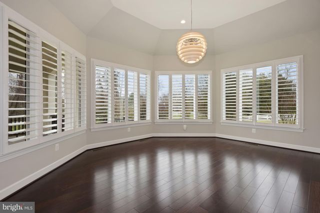 a large white bed in a room next to a window