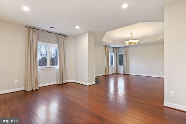 a spacious bathroom with a tub double sink and mirror