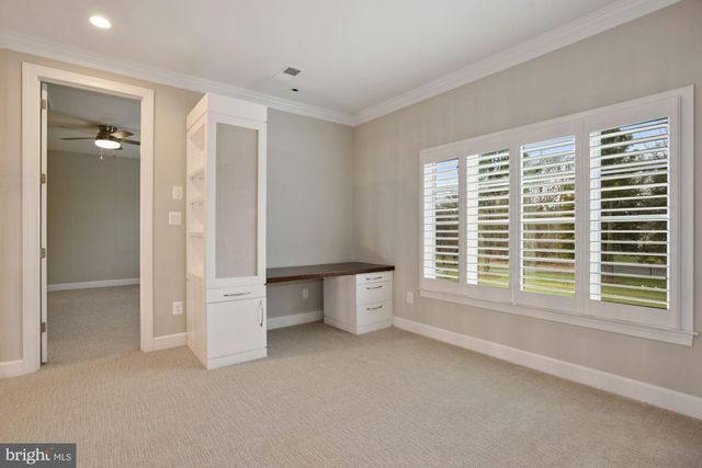 a view of empty room with wooden floor and window