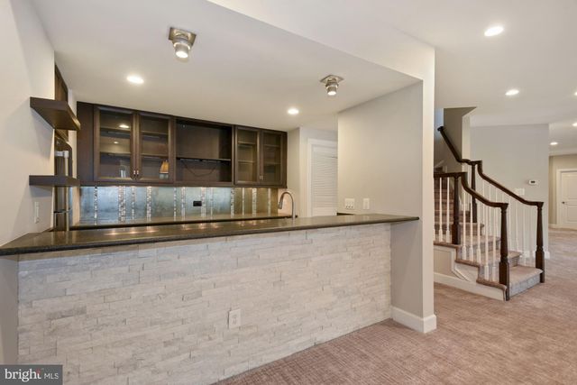 a bathroom with a granite countertop sink toilet a mirror and shower