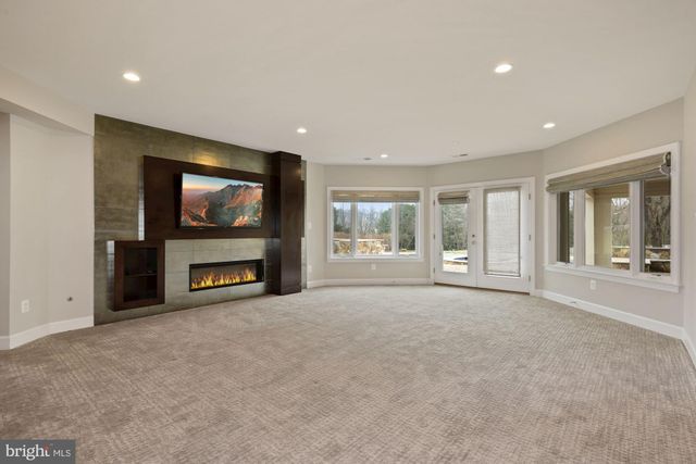 a room with gym equipment and a view of living room