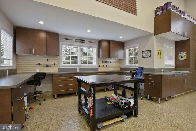 an aerial view of a house with a garden and lake view