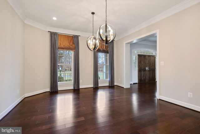 a view of a room with wooden floor and white walls