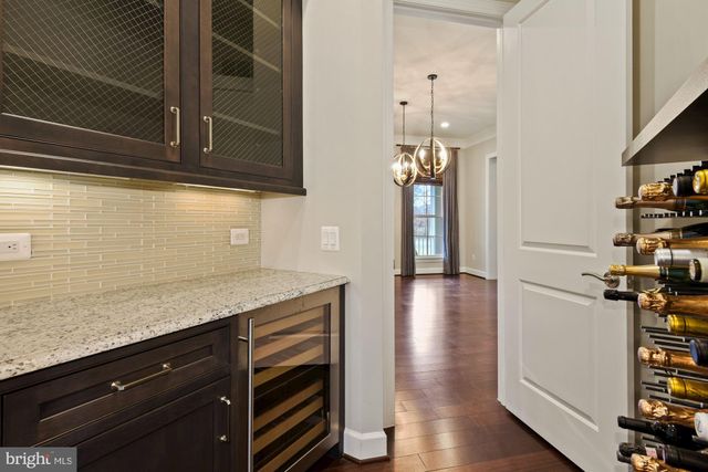 a open kitchen with stainless steel appliances granite countertop a refrigerator a sink dishwasher a stove and a wooden floor