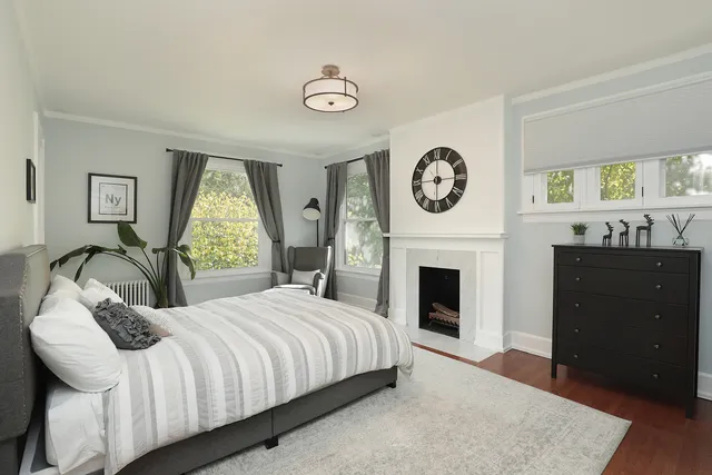 a bedroom with a bed and a fireplace