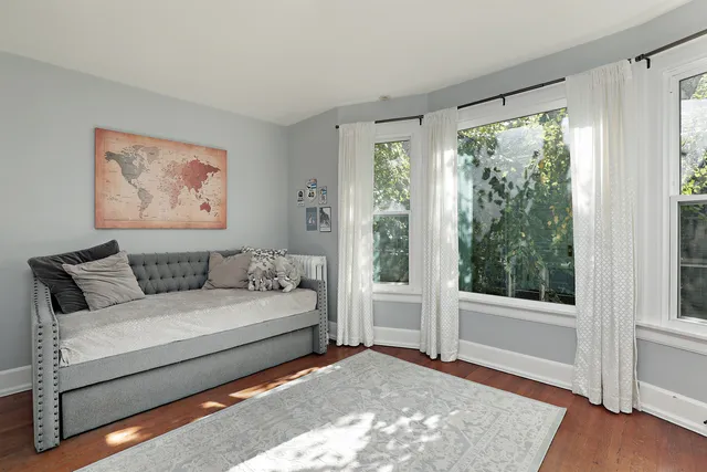 a bedroom with a large bed and a window