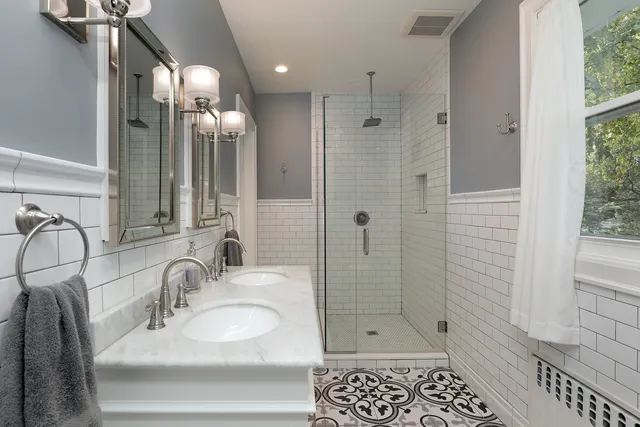 a bathroom with a shower sink and mirror