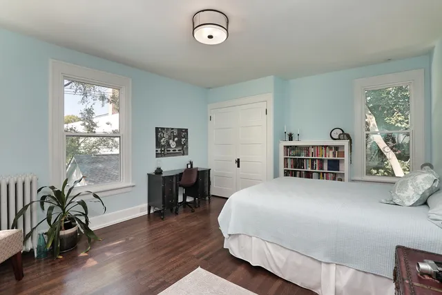 a bedroom with furniture and a wooden floor