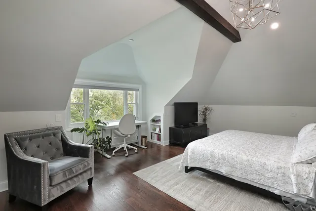 a bedroom with a bed wooden floor and furniture