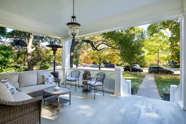 a living room with patio furniture and a garden