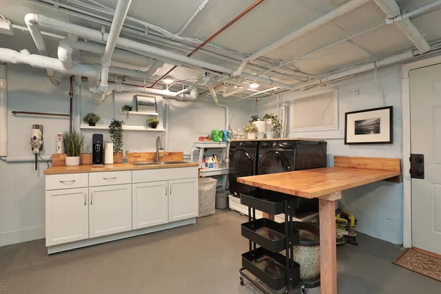 a kitchen with a table chairs and refrigerator