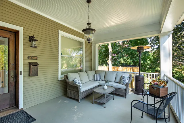 a balcony with furniture and a ceiling fan