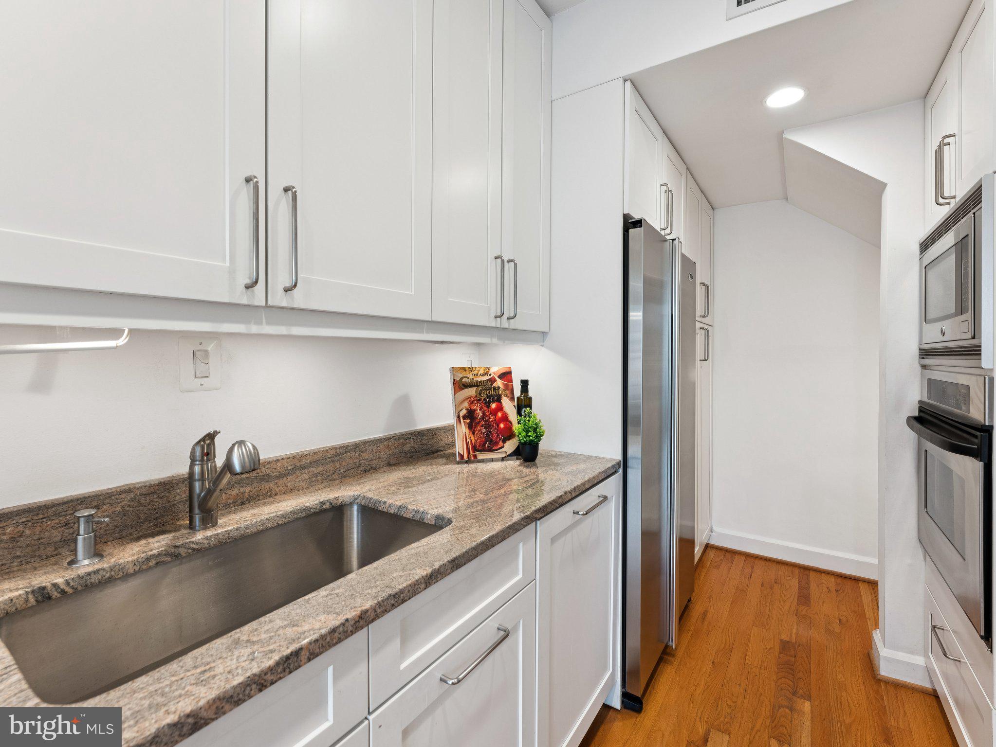 3541 R Street Northwest Washington, DC 20007 - Photo 16 of 35 a kitchen with stainless steel appliances granite countertop a sink and a refrigerator