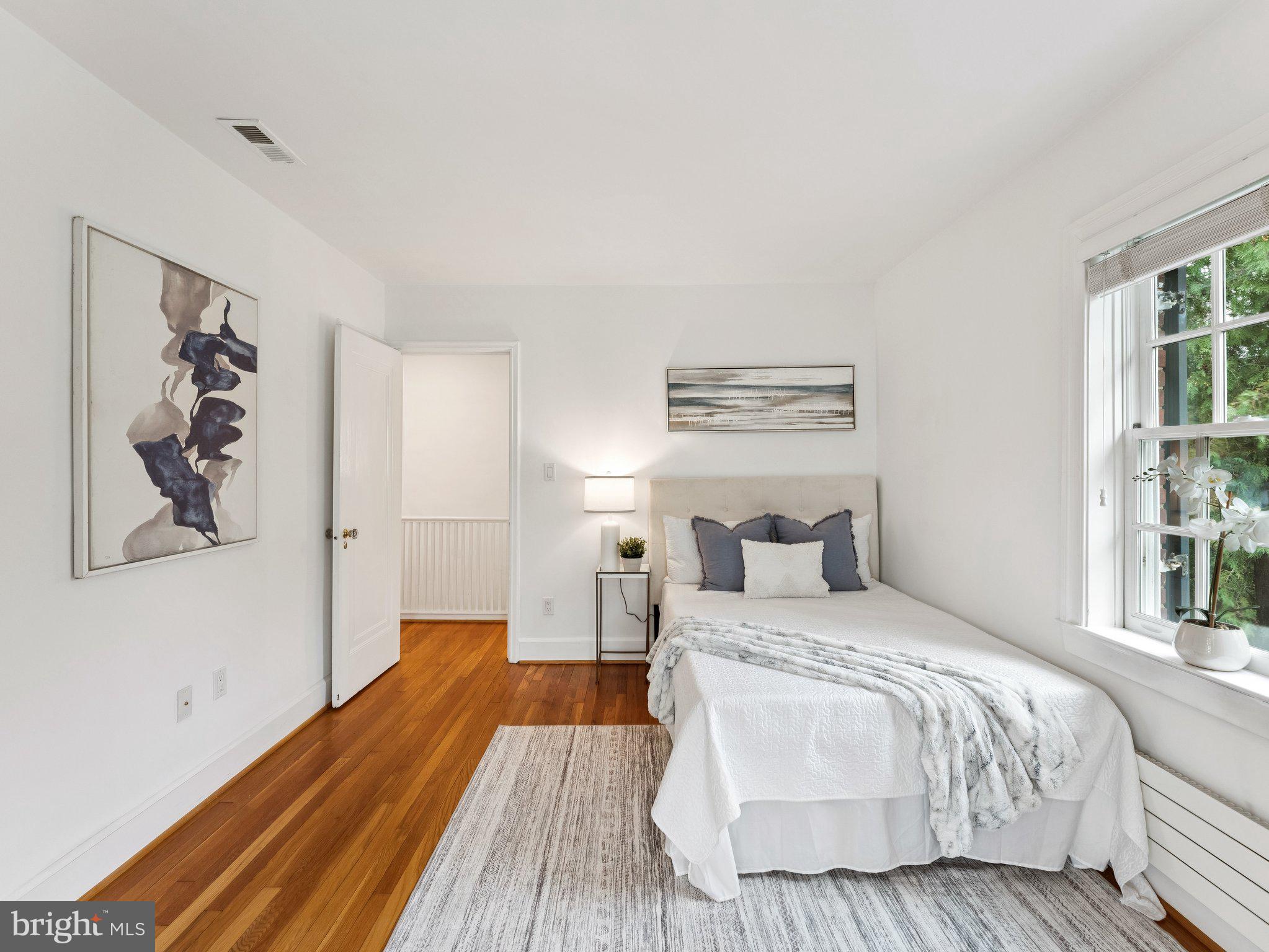 3541 R Street Northwest Washington, DC 20007 - Photo 20 of 35 a bedroom with a bed and a painting on the wall