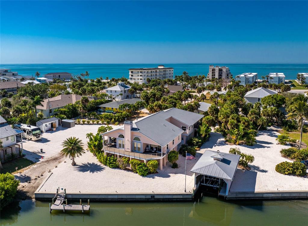 an aerial view of a house with a ocean view