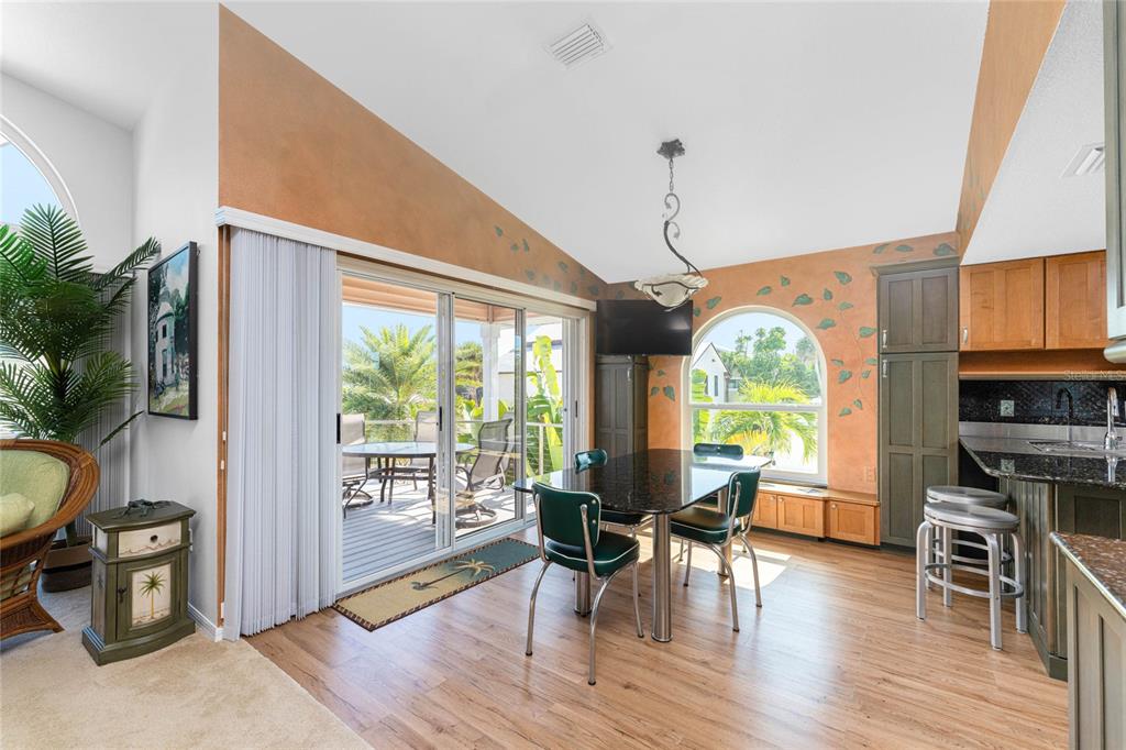 2805 North Beach Road, Unit B Englewood, FL 34223 - Photo 12 of 86 a view of a dining room with furniture window and wooden floor