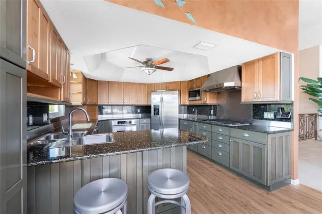 a kitchen with stainless steel appliances granite countertop a stove and a sink