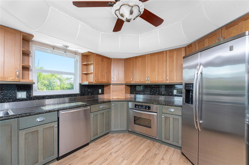 2805 North Beach Road, Unit B Englewood, FL 34223 - Photo 16 of 86 a kitchen with a sink stainless steel appliances and window