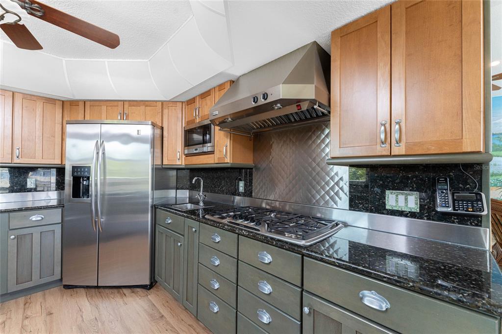 2805 North Beach Road, Unit B Englewood, FL 34223 - Photo 17 of 86 a kitchen with stainless steel appliances granite countertop a sink a stove and a refrigerator