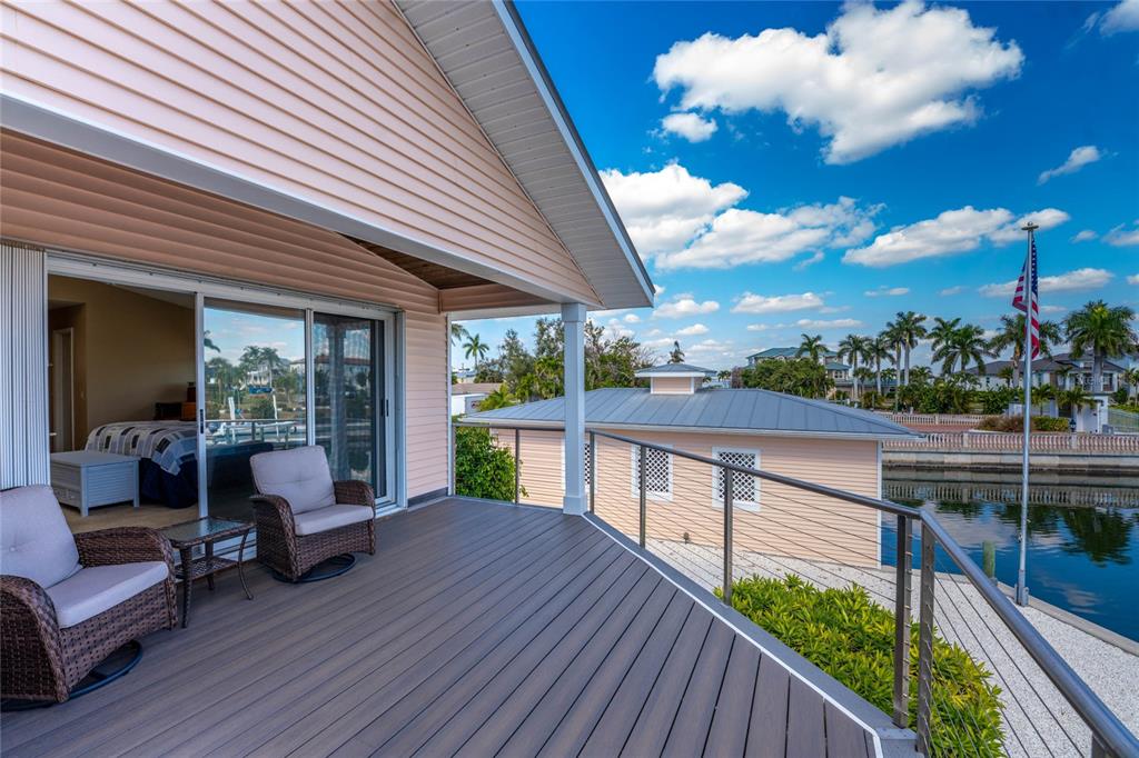 2805 North Beach Road, Unit B Englewood, FL 34223 - Photo 25 of 86 a balcony with furniture and wooden floor