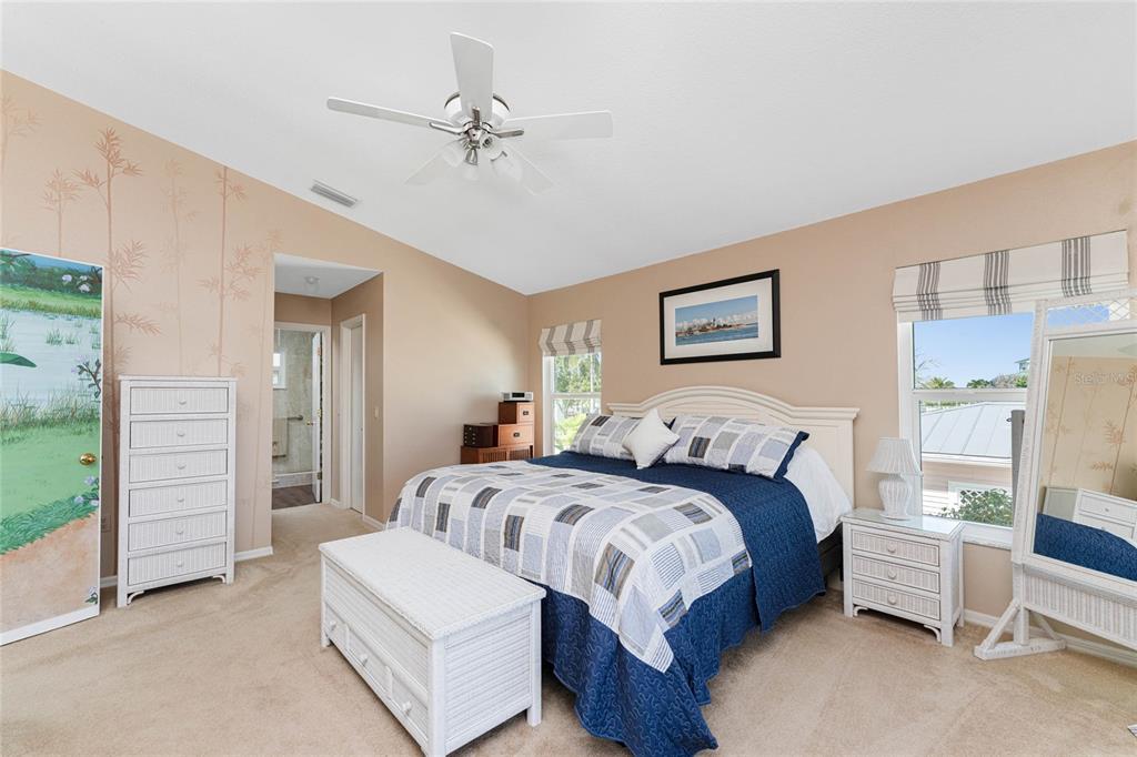 2805 North Beach Road, Unit B Englewood, FL 34223 - Photo 32 of 86 a bedroom with a bed and a chandelier