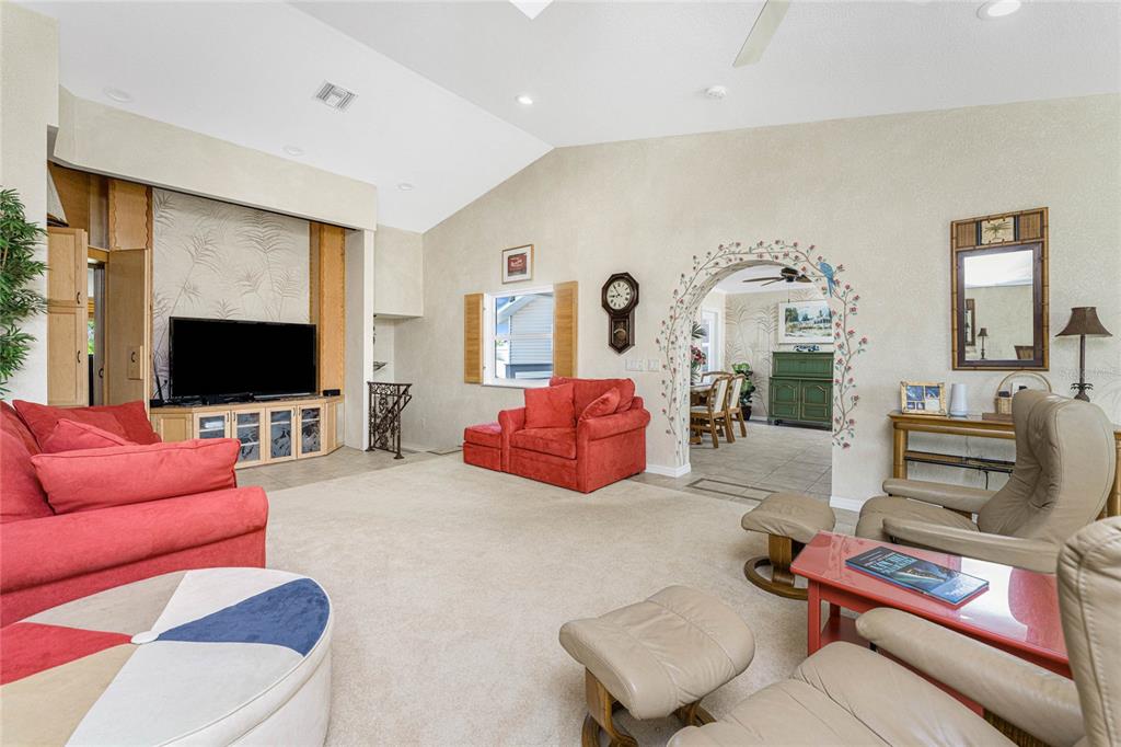 2805 North Beach Road, Unit B Englewood, FL 34223 - Photo 36 of 86 a living room with furniture kitchen view and a flat screen tv