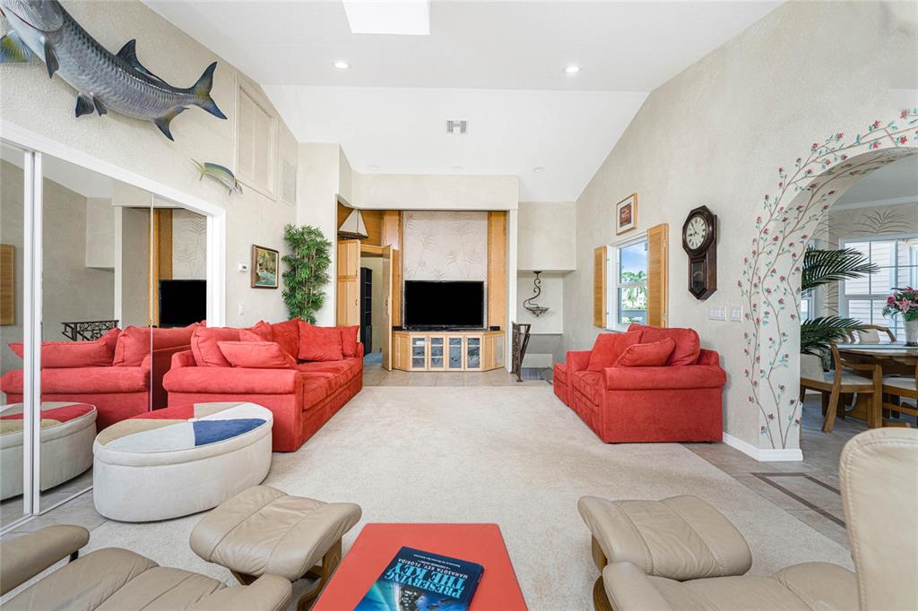 2805 North Beach Road, Unit B Englewood, FL 34223 - Photo 38 of 86 a living room with furniture and a flat screen tv