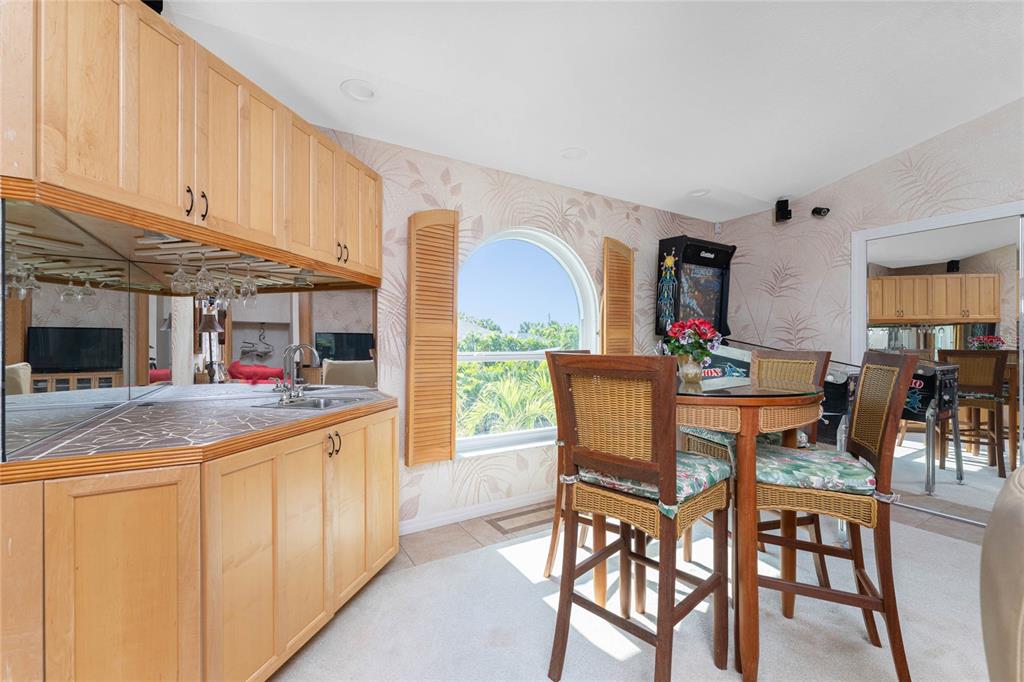 2805 North Beach Road, Unit B Englewood, FL 34223 - Photo 43 of 86 a dining hall with stainless steel appliances granite countertop a dining table and chairs