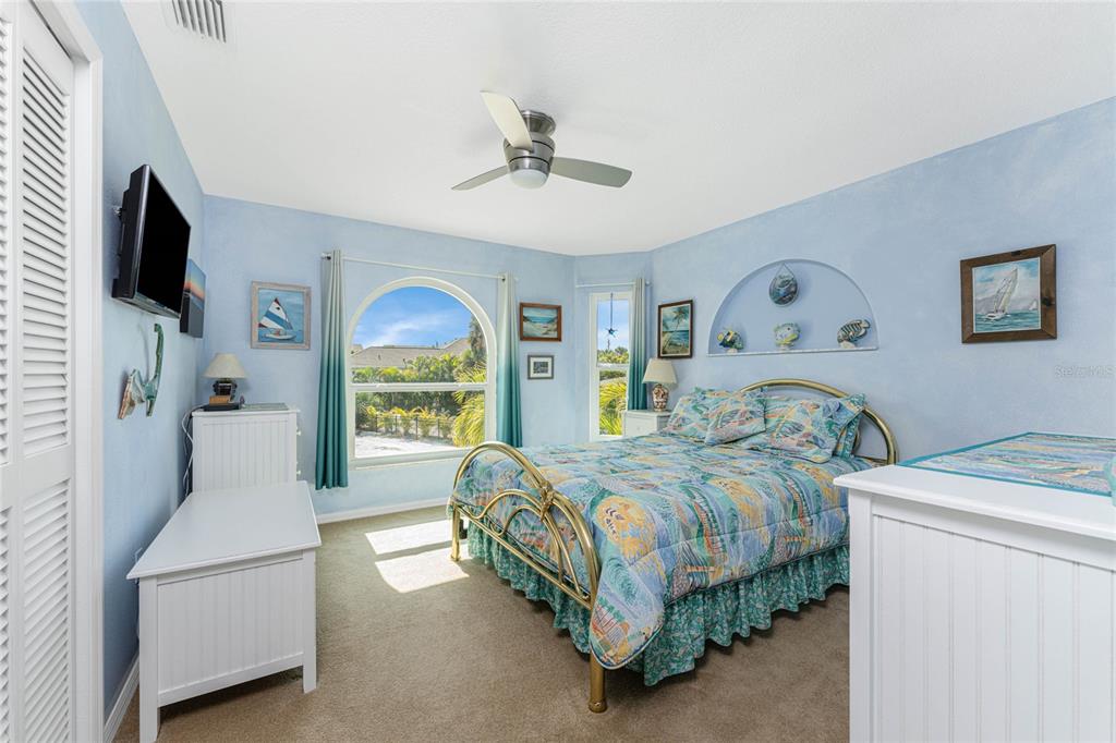 2805 North Beach Road, Unit B Englewood, FL 34223 - Photo 45 of 86 a bedroom with a bed and a flat screen tv