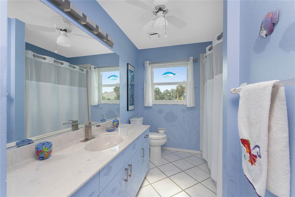 2805 North Beach Road, Unit B Englewood, FL 34223 - Photo 47 of 86 a bathroom with a sink vanity and a mirror