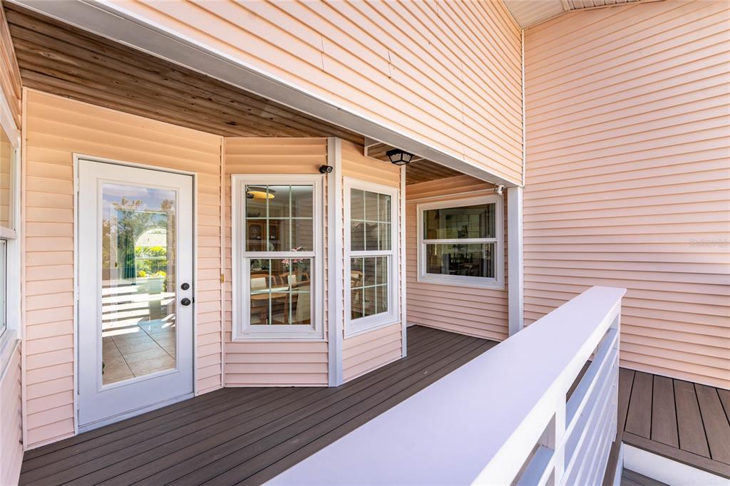2805 North Beach Road, Unit B Englewood, FL 34223 - Photo 52 of 86 a view of a deck with wooden floor and fence