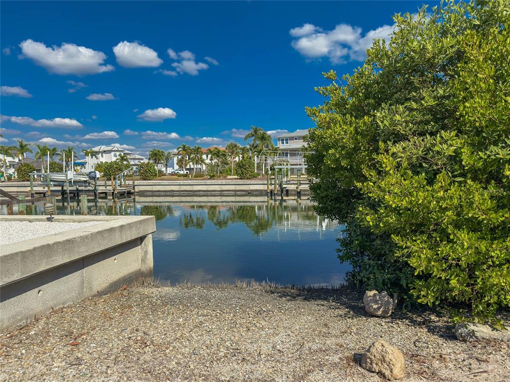 2805 North Beach Road, Unit B Englewood, FL 34223 - Photo 63 of 86 a view of a lake with a building in the background