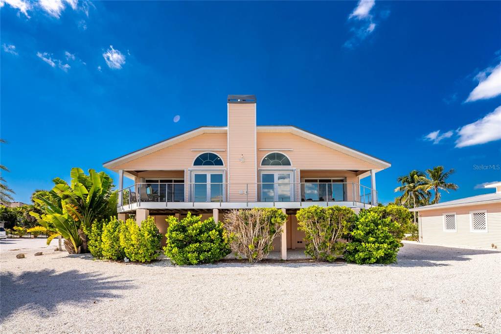 2805 North Beach Road, Unit B Englewood, FL 34223 - Photo 65 of 86 a view of a house with a yard and plant