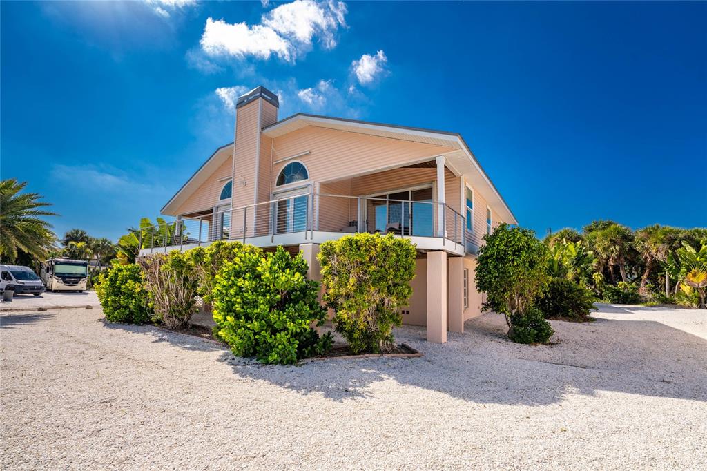 2805 North Beach Road, Unit B Englewood, FL 34223 - Photo 66 of 86 a front view of a house with a yard