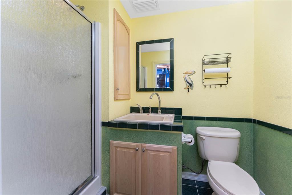 2805 North Beach Road, Unit B Englewood, FL 34223 - Photo 72 of 86 a bathroom with a toilet a sink and mirror