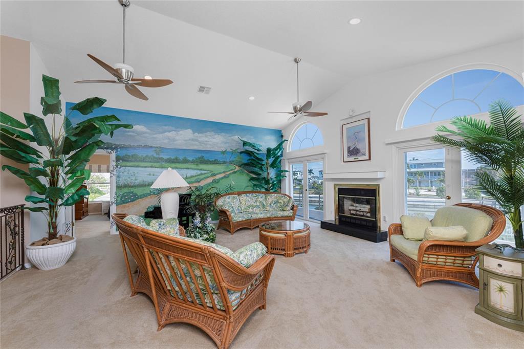 2805 North Beach Road, Unit B Englewood, FL 34223 - Photo 9 of 86 a living room with furniture and a fireplace