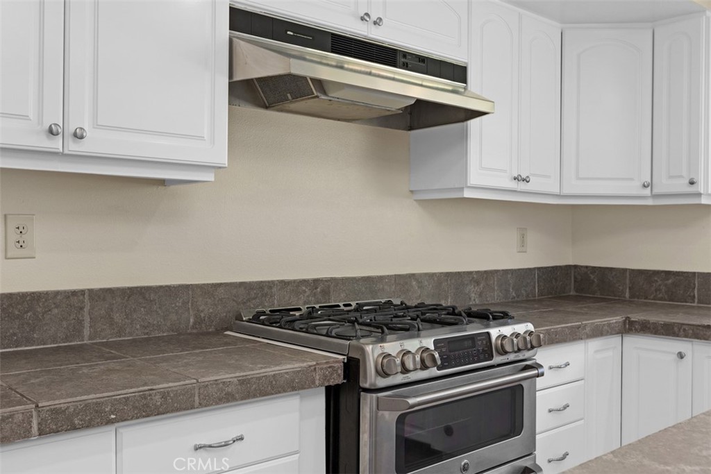35768 Rice Canyon Road Fallbrook, CA 92028 - Photo 14 of 39 a white stove top oven sitting inside of a kitchen