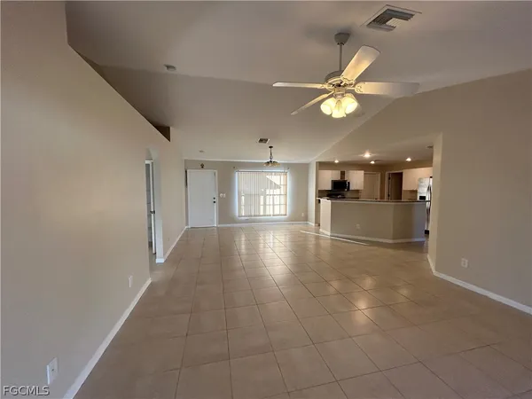 a view of a livingroom with a ceiling fan and window