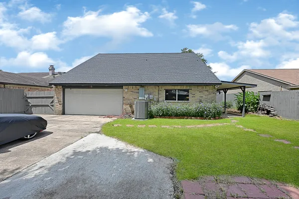 a front view of a house with a garden and yard